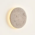 Aplique de pared redondo de travertino con luz de halo Eclipse